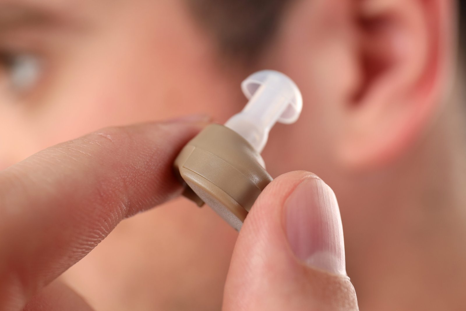 Concept of health care with hearing aid, close up